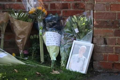 Flowers placed at the entrance to the Holt School, Wokingham, Berskhire, in memory of the first victim named, teacher James Furlong