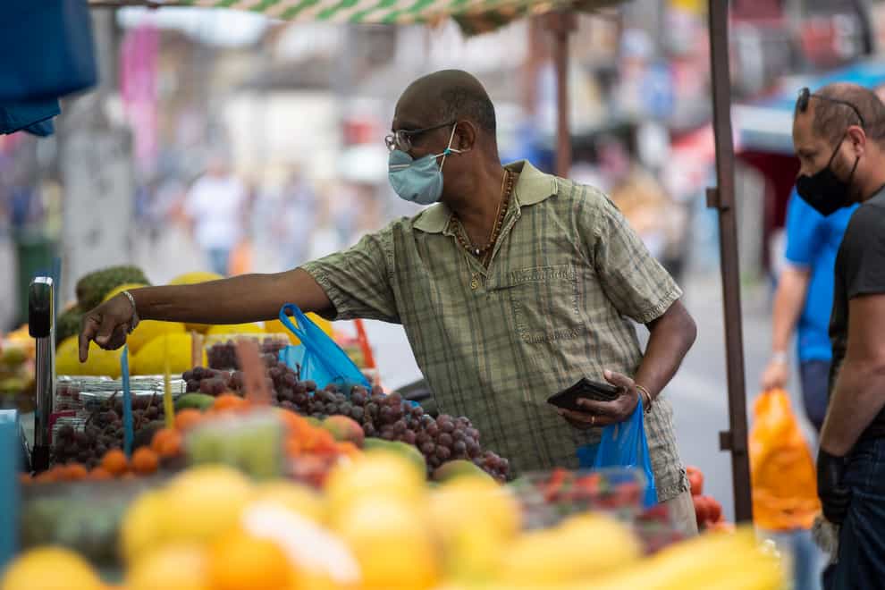 A man at a fruit an veg stall