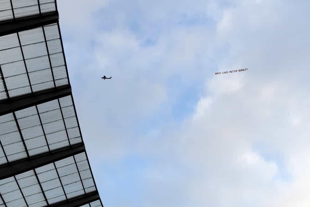 A plane flies over the Etihad Stadium with a banner reading ‘White Lives Matter Burnley’