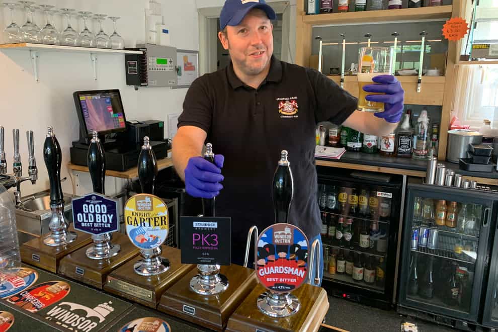 Neil Piddington, general manager of the Craufurd Arms community-owned pub in Maidenhead, checks the beer after Prime Minister Boris Johnson said that pubs, restaurants and cinemas in England will be able to reopen from July 4