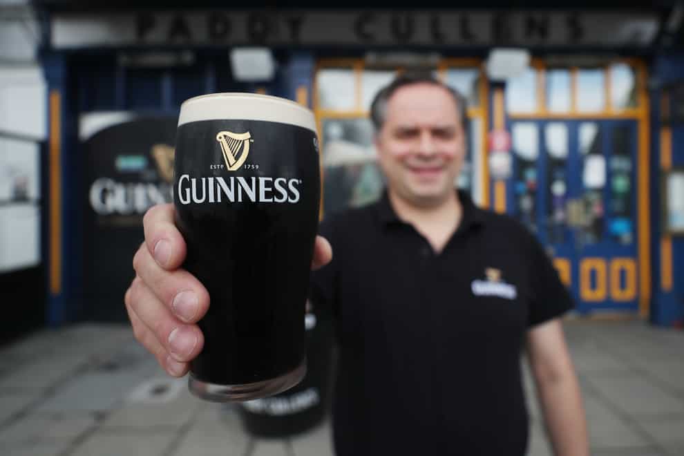 Mariusz Brzyk assistant manager of Paddy Cullens pub in Dublin takes delivery of fresh Guinness (Niall Carson/PA)