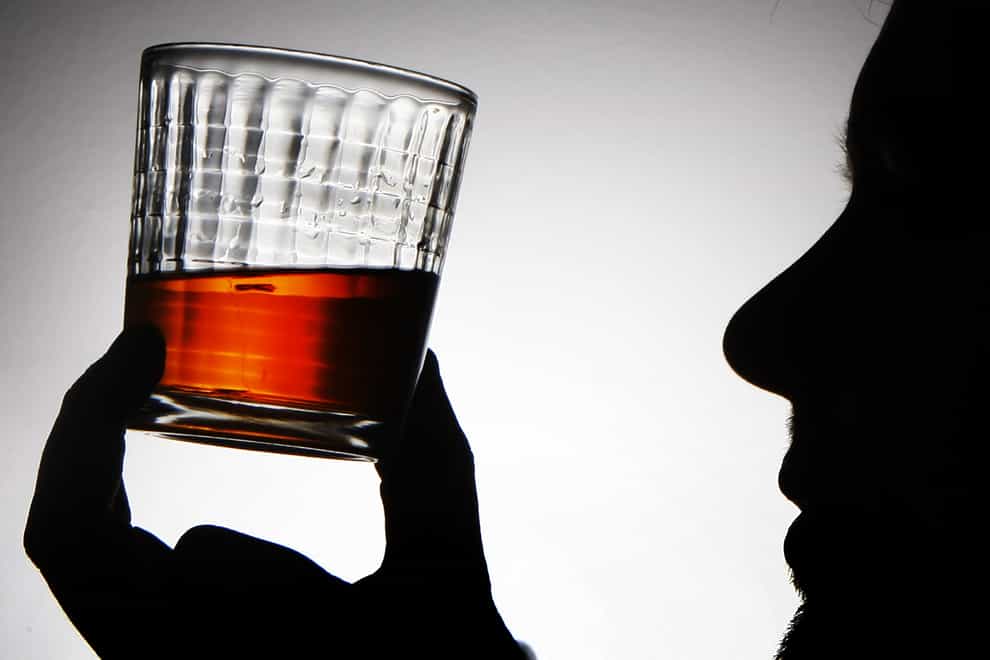A glass of whisky being held up