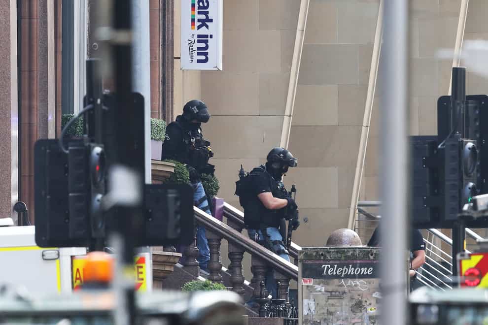 Armed police officers leave the Park Inn hotel in West George Street