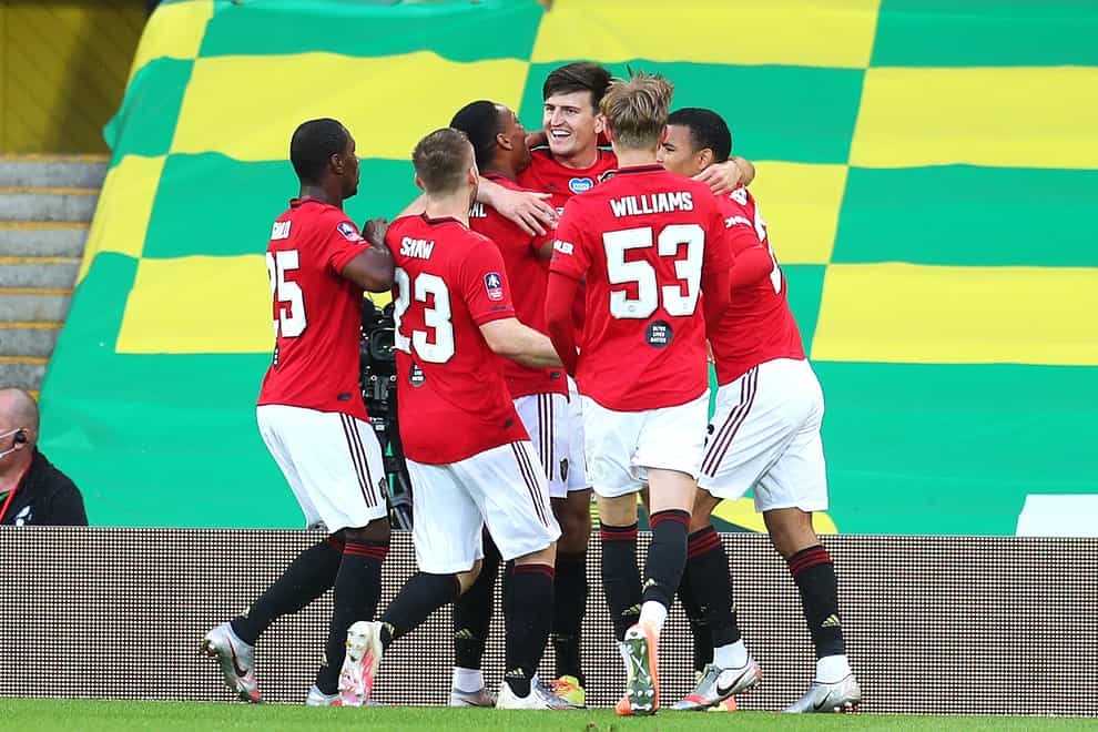 Harry Maguire, centre, scored Manchester United's winner at Carrow Road
