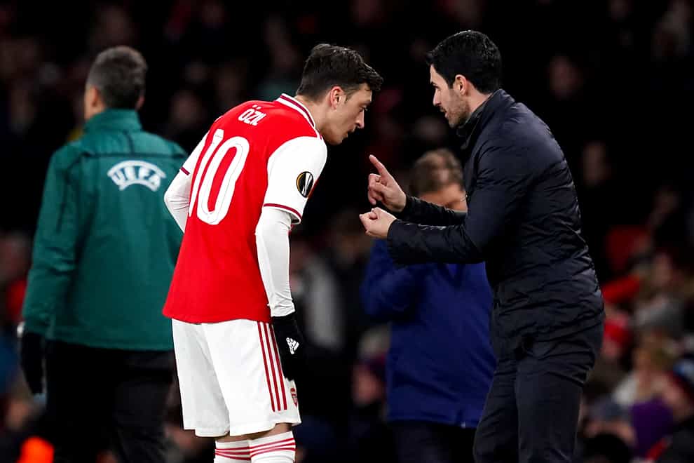 Arsenal manager Mikel Arteta, right, insists Mesut Ozil's wage does not impact his selection