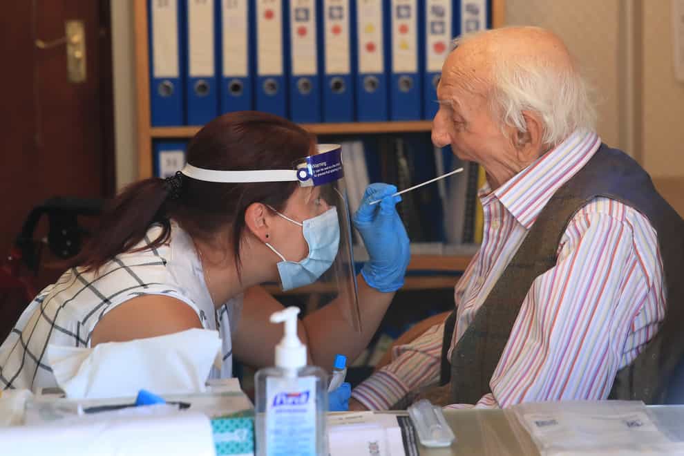 A care home resident undergoes a coronavirus swab test