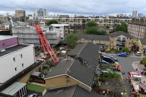 The crane crashed through the roof of a terraced house, trapping people  inside