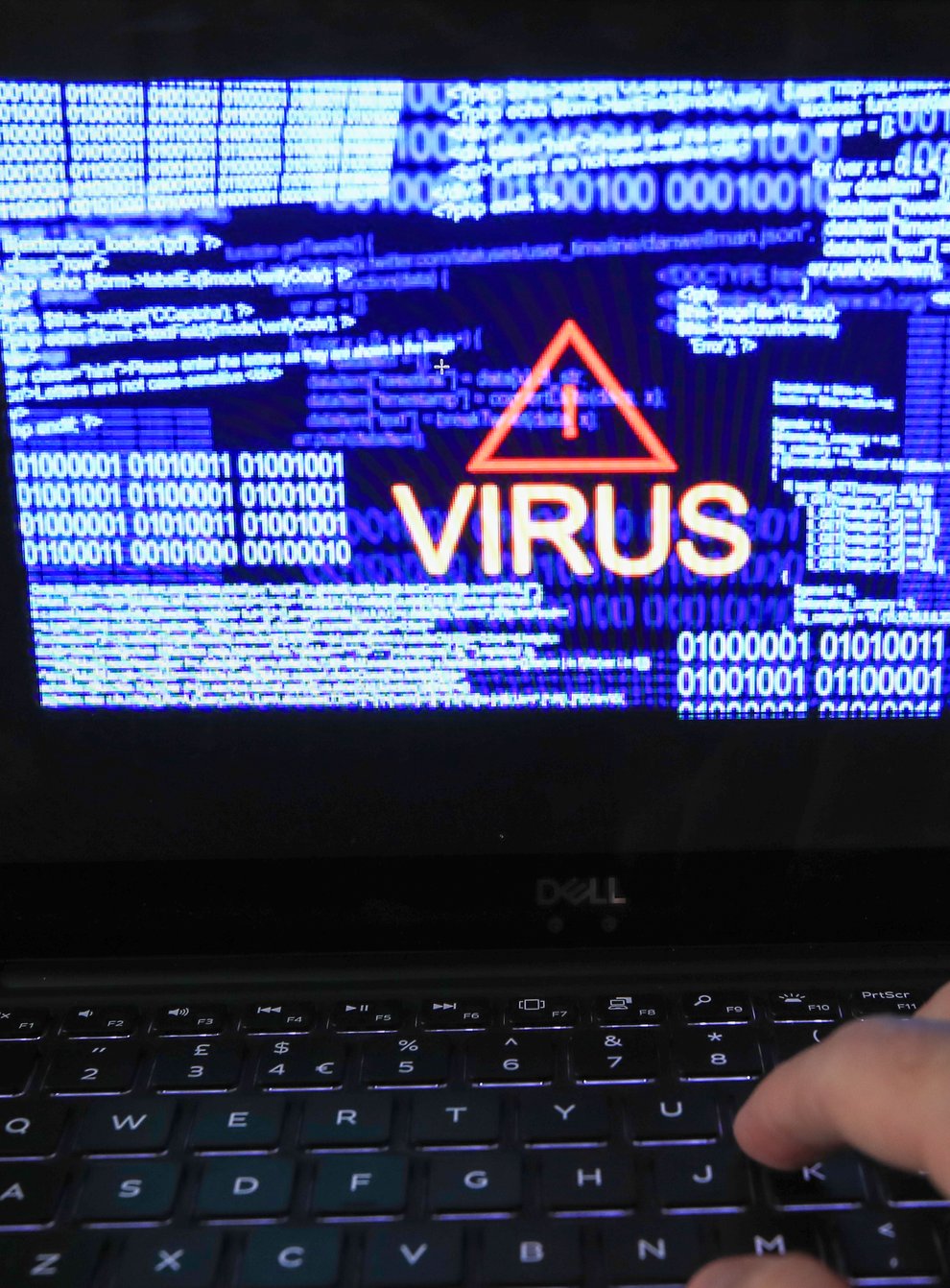 A laptop screen showing a computer virus warning