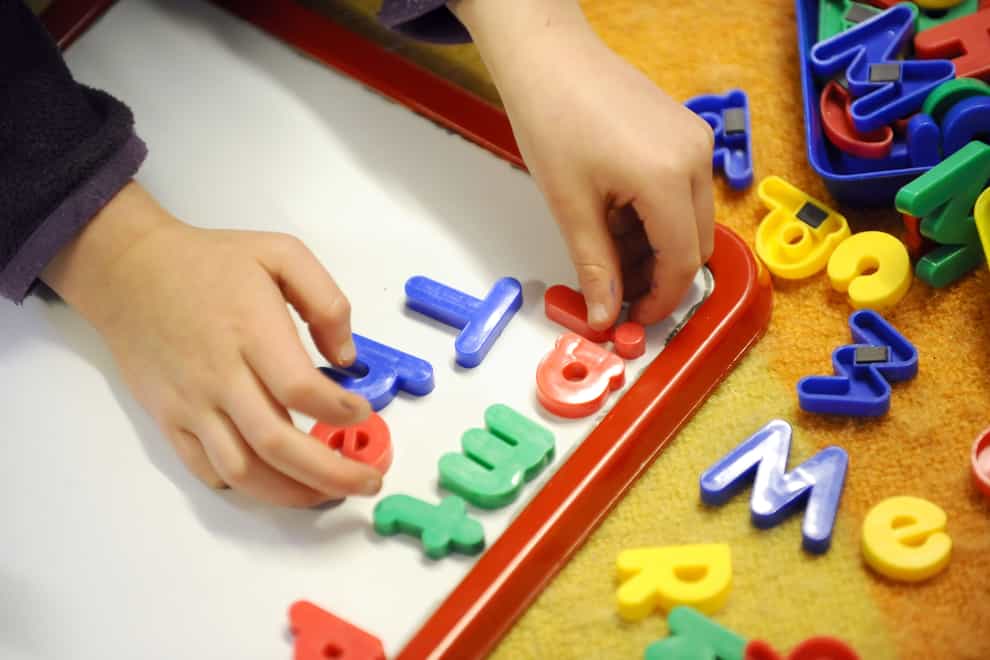 A child playing with letters