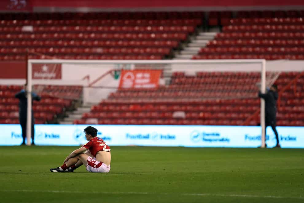 A dejected Joe Lolley sits on the ground alone in the aftermath of Nottingham Forest's utter capitulation against Stoke on Wednesday night.