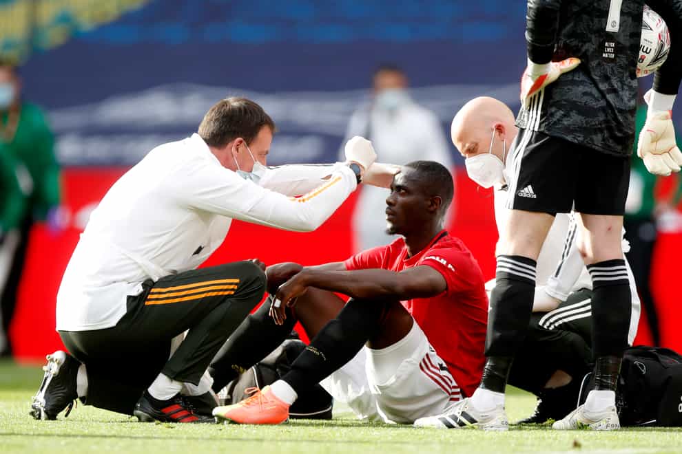 Manchester United’s Eric Bailly receives medical treatment after a clash of heads