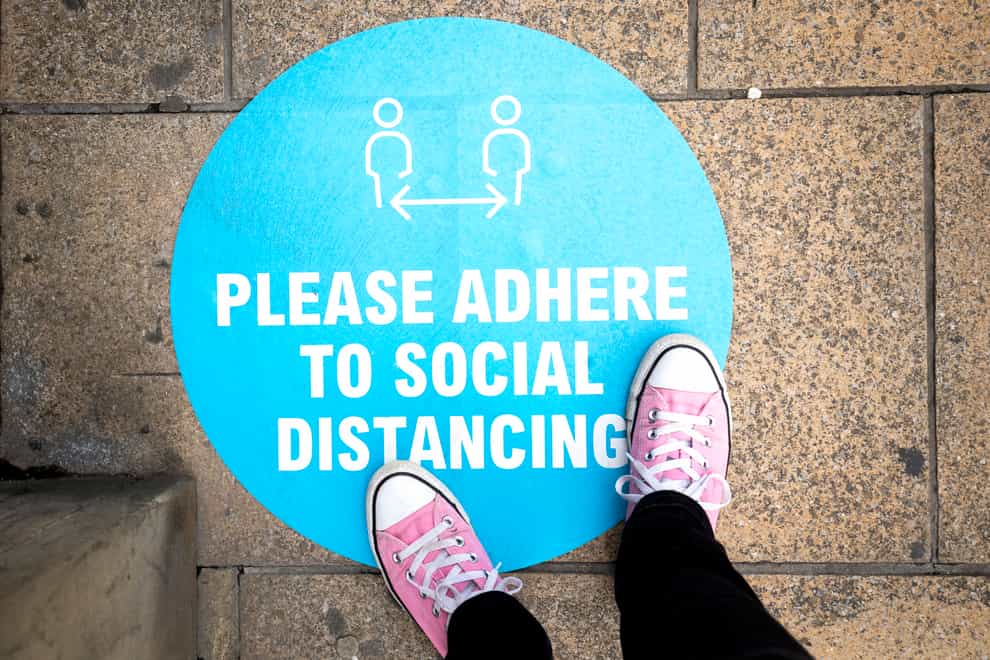 A social distancing sign outside a shop