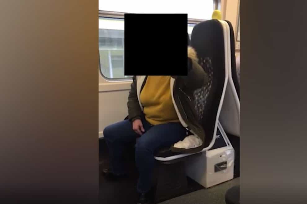 Screen grab from handout footage issued by Sense of a passenger on a Merseyrail train who challenged Karolina Pakenaite, 24, who is deafblind, and her sister, Saule, 16, who has Usher’s Syndrome