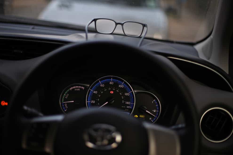 A pair of glasses on a car dashboard