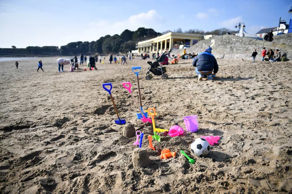 Buckets, spades and toys on the beach during sunny weather at Barry Island in South Wales (Ben Birchall/PA)