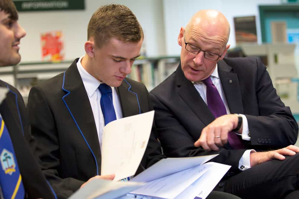 John Swinney with a pupil checking their results