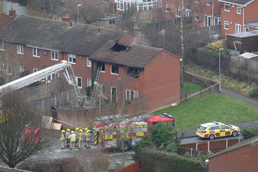 Firefighters at the scene of a house fire in Sycamore Lane, Stafford, which claimed the lives of four children