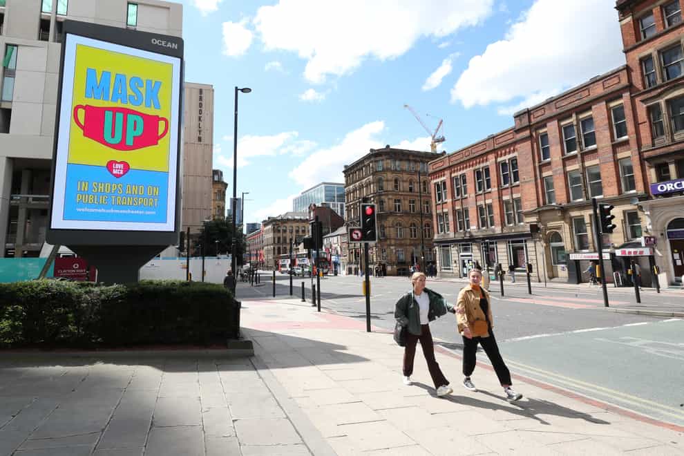 Manchester City Council advertising regarding the guidelines on wearing masks on a billboard in Manchester