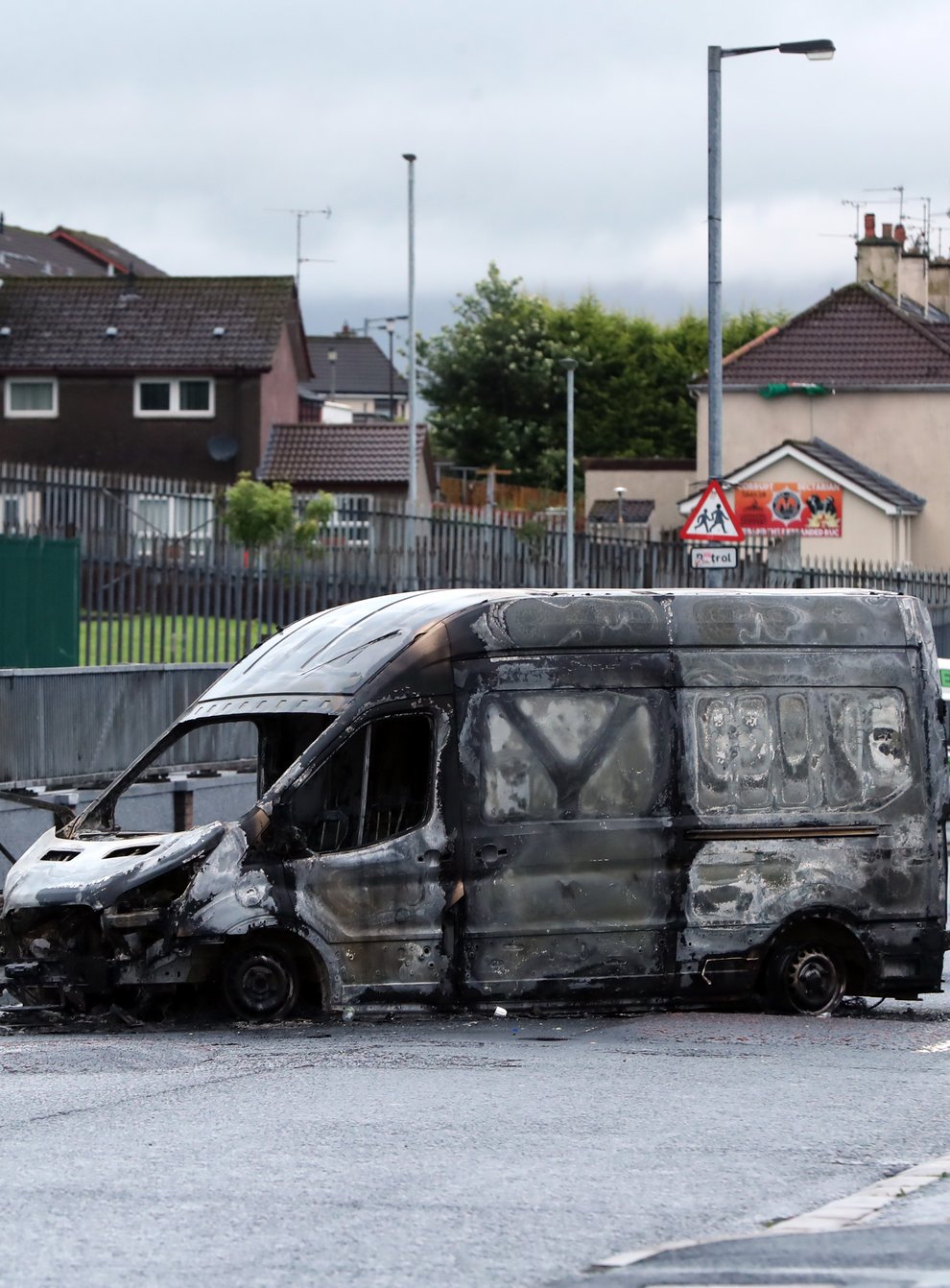 A burnt-out van in the Creggan area of Londonderry as the coffin of John Hume is taken to St Eugene’s Cathedral ahead of his funeral