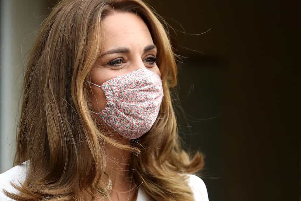 The Duchess of Cambridge wears a mask in public for the first time during a charity visit