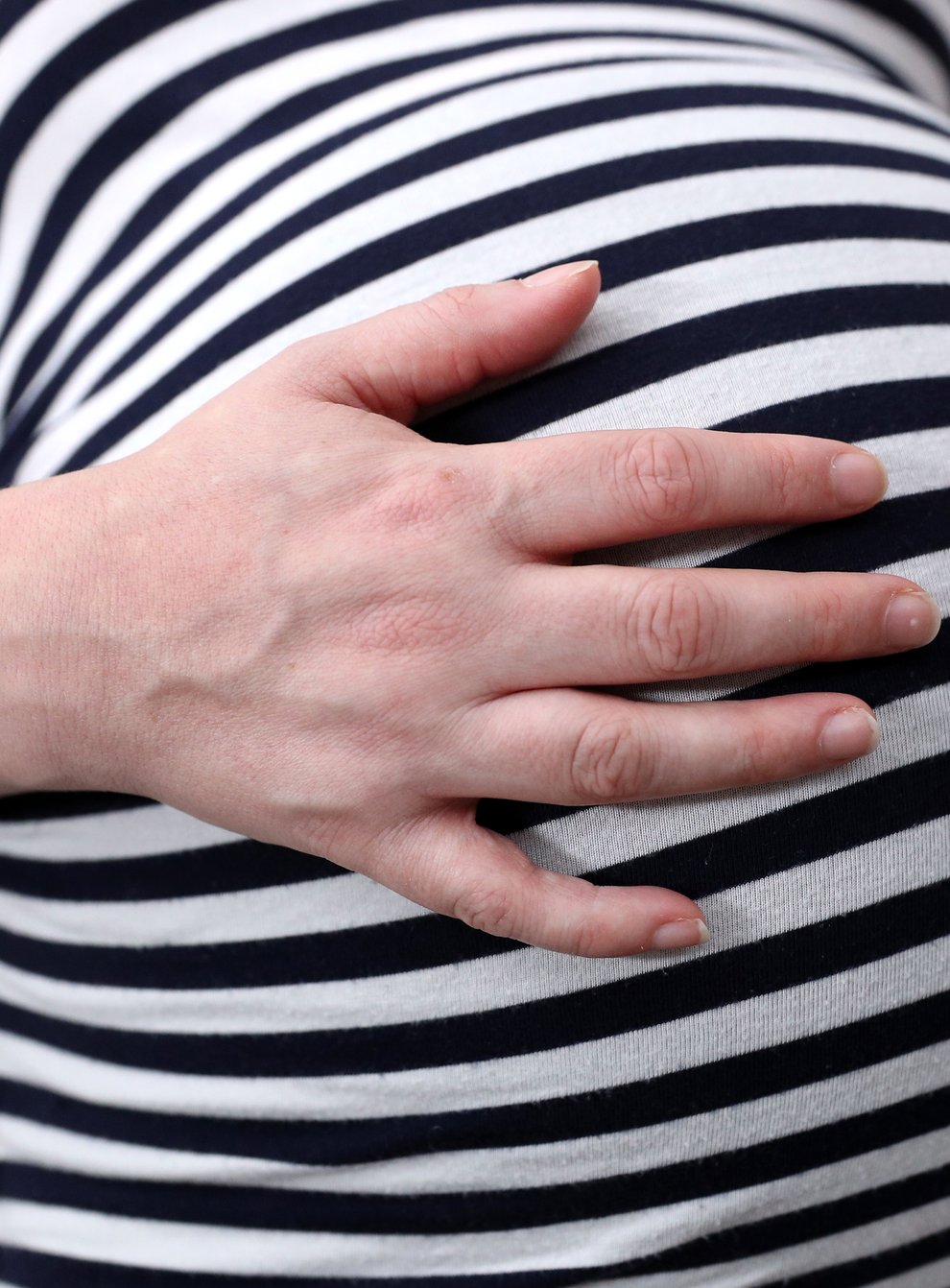 Pregnant woman holds her stomach