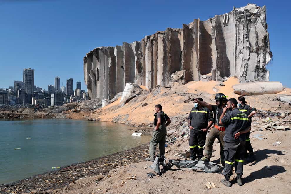A rescue team surveys the site of the massive explosion in the port of Beirut, Lebanon