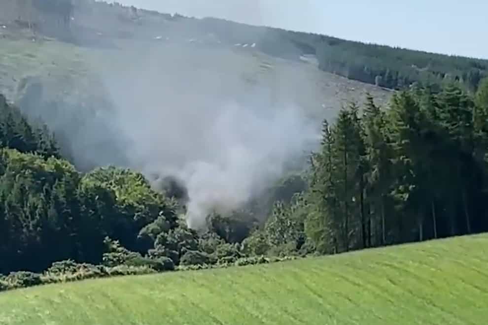 Smoke billows from the scene where a train derailed near Aberdeen this morning, before bursting into flames