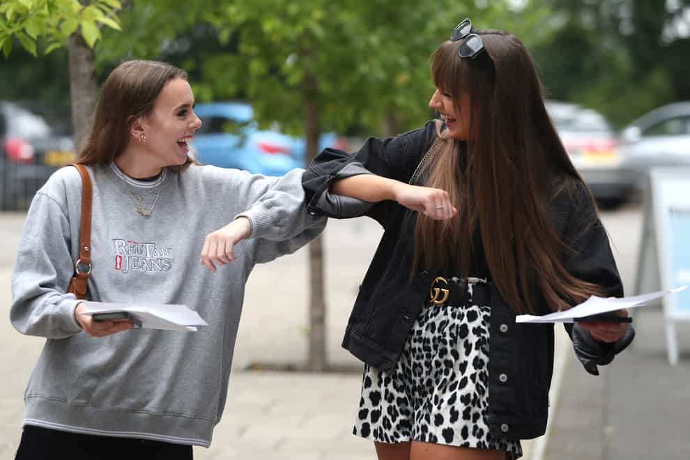 Friends Helen Lee, left, and Sophia-Ellis Shipp congratulate each other at Peter Symonds College, Winchester, after opening their A-level results