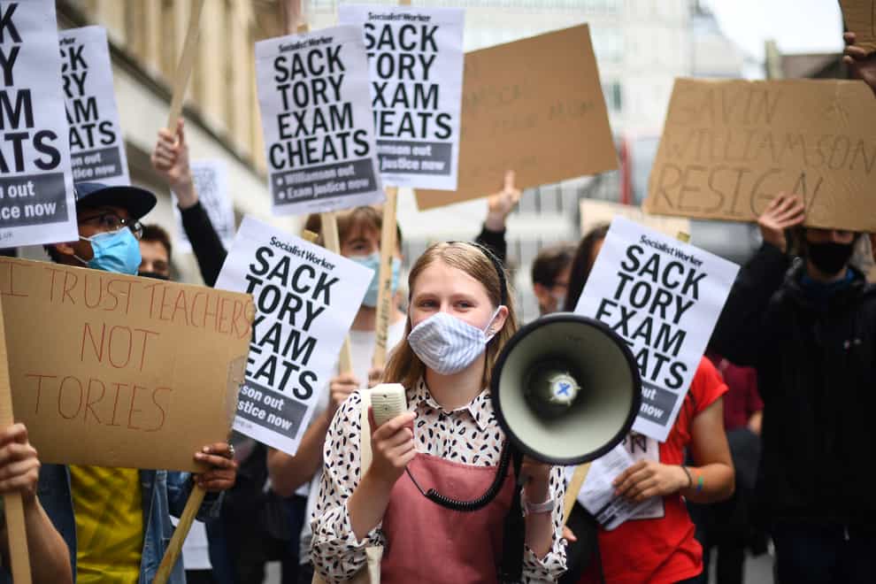 People take part in a protest outside the Department for Education in Westminster, London