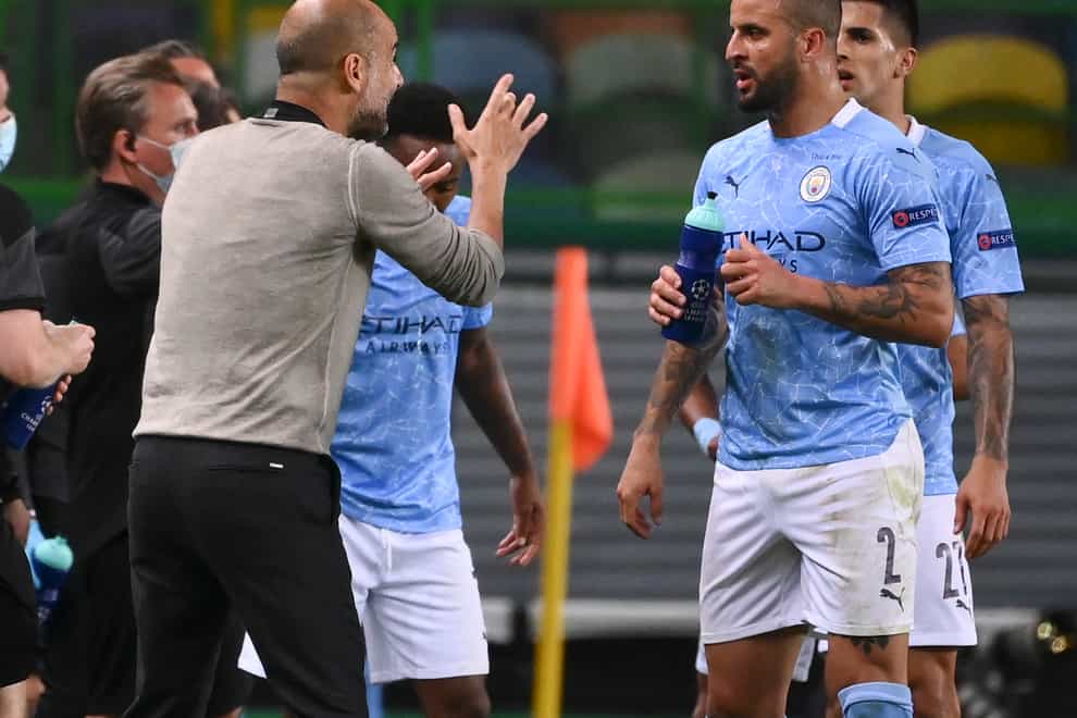 Manchester City head coach Pep Guardiola left, talks to Kyle Walker during the defeat by Lyon