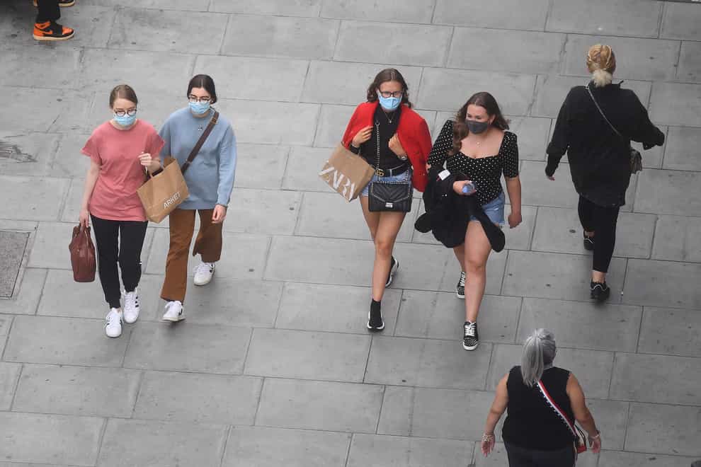 People wearing face masks while shopping