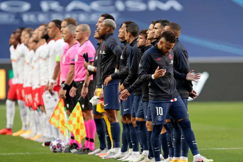PSG's Neymar, right, gestures as the teams line-up before the Champions League semifinal soccer match between RB Leipzig and Paris Saint-Germain at the Luz stadium in Lisbon, Portugal