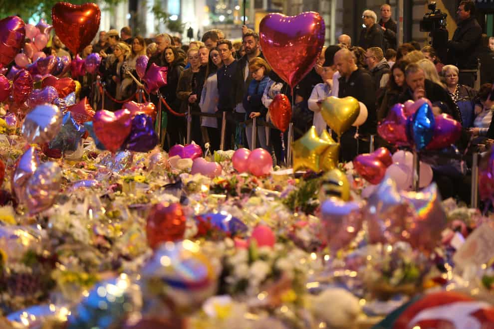 Mourners viewing tributes in St Ann’s Square, Manchester, a week after the Manchester Arena terror attack (Jonathan Brady/PA)