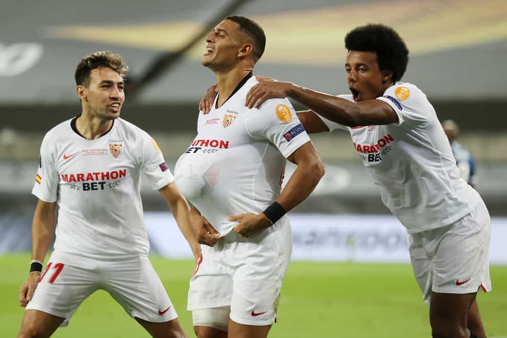 Sevilla’s Diego Carlos (centre) celebrates with his team-mates after Romelu Lukaku had turned his overhead kick into his own goal