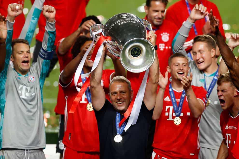 Bayern Munich’s head coach Hansi Flick lifts the Champions League trophy after victory over Paris St Germain