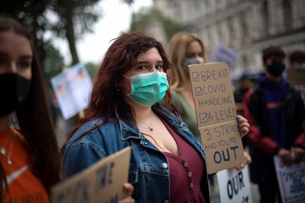 Students wearing face masks take part in a protest in Westminster