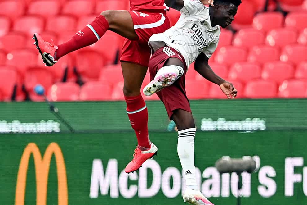 Liverpool’s Virgil van Dijk (left), pictured challenging Arsenal's Bukayo Saka, says the champions should not panic over their Community Shield defeat against the Gunners at Wembley.