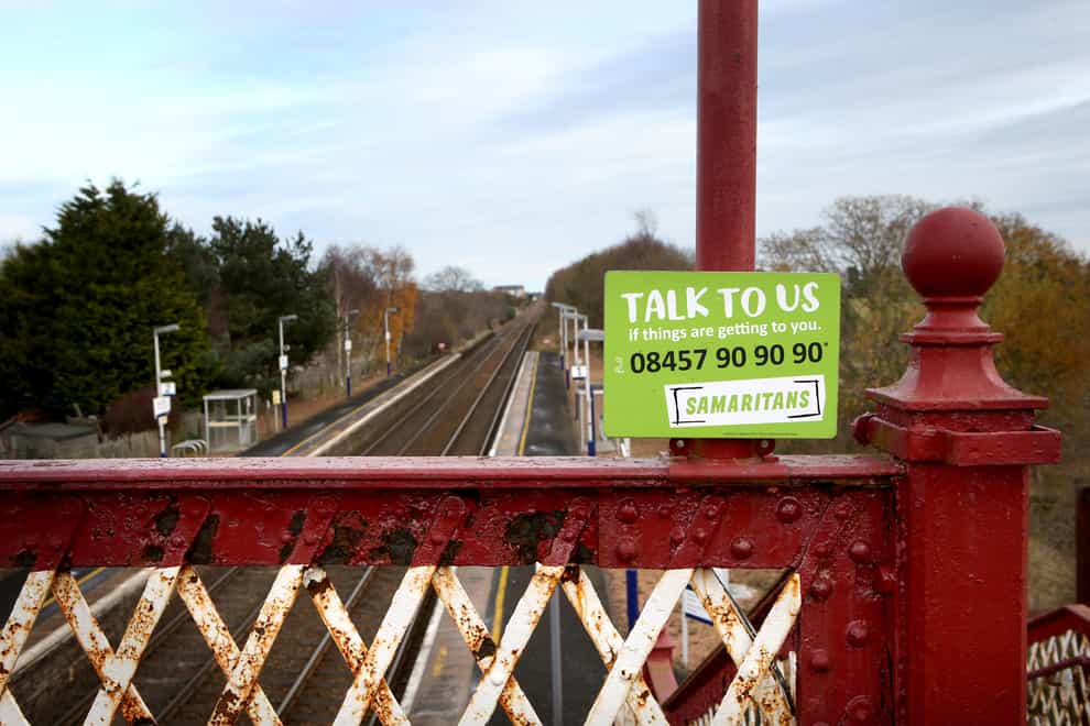 A Samaritans notice on a bridge over railway lines