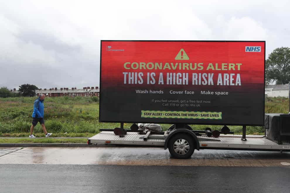 A mobile advertising vehicle displaying a coronavirus high risk area warning in Oldham
