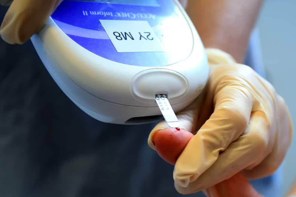 Nurse gives patient a diabetes test