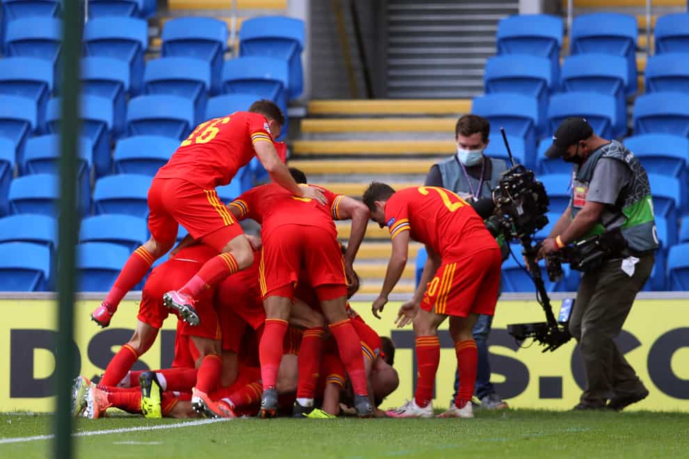 Wales celebrate after Neco Williams, obscured, scores against Bulgaria