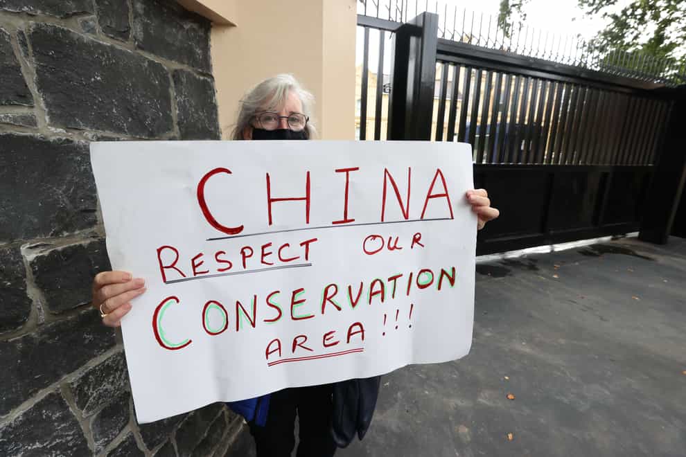 A resident protests outside the Chinese Consulate, Belfast