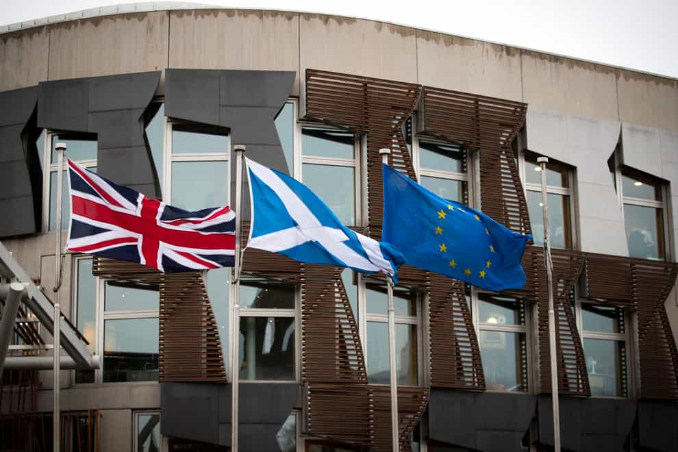 The union flag, saltire and EU flag fly outside the Scottish Parliament in Edinburgh