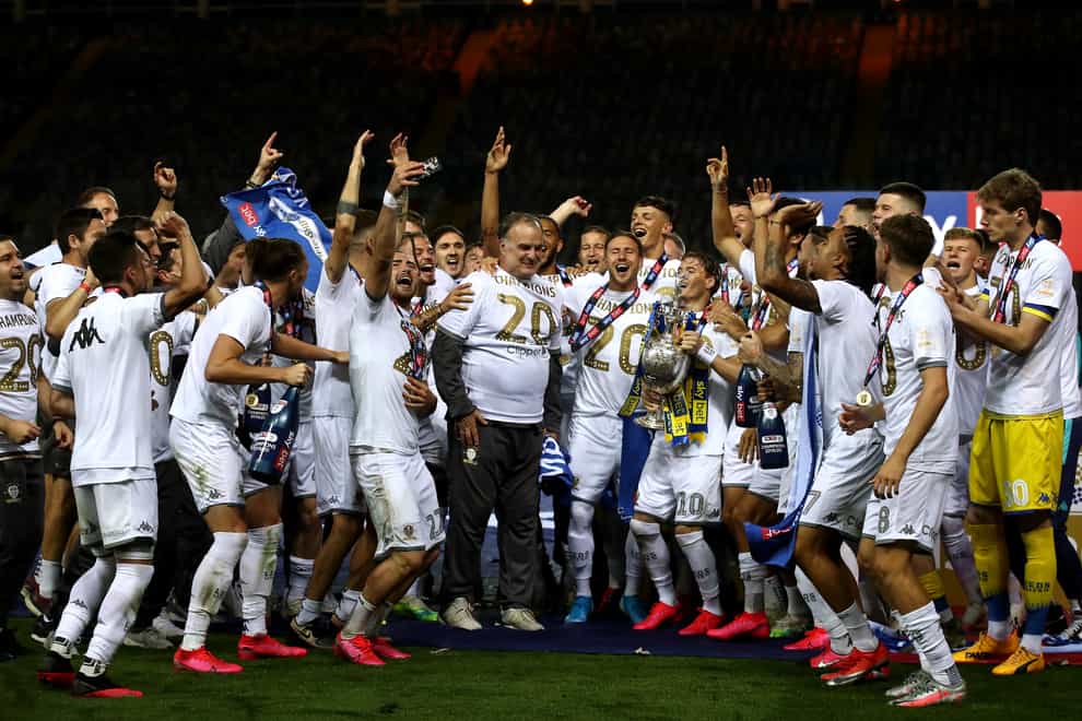 Leeds manager Marcelo Bielsa celebrates with his players as they lift the Sky Bet Championship trophy