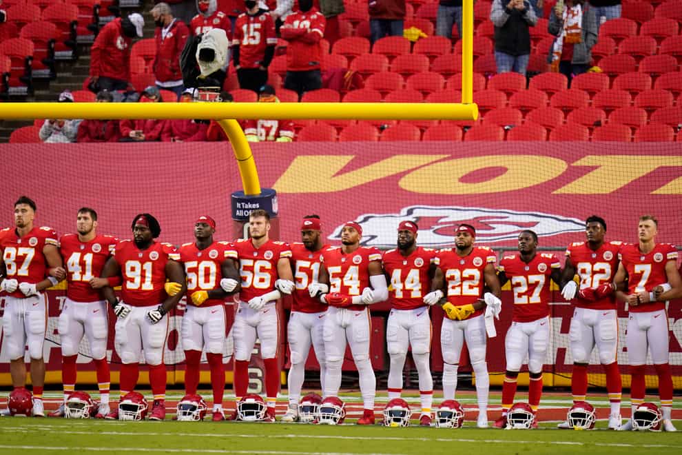Kansas City Chiefs players link arms in a moment of unity (Charlie Riedel/AP)