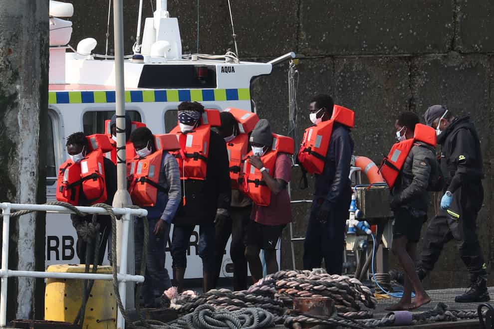 A group of people thought to be migrants are brought into Dover, Kent, by Border Force officers