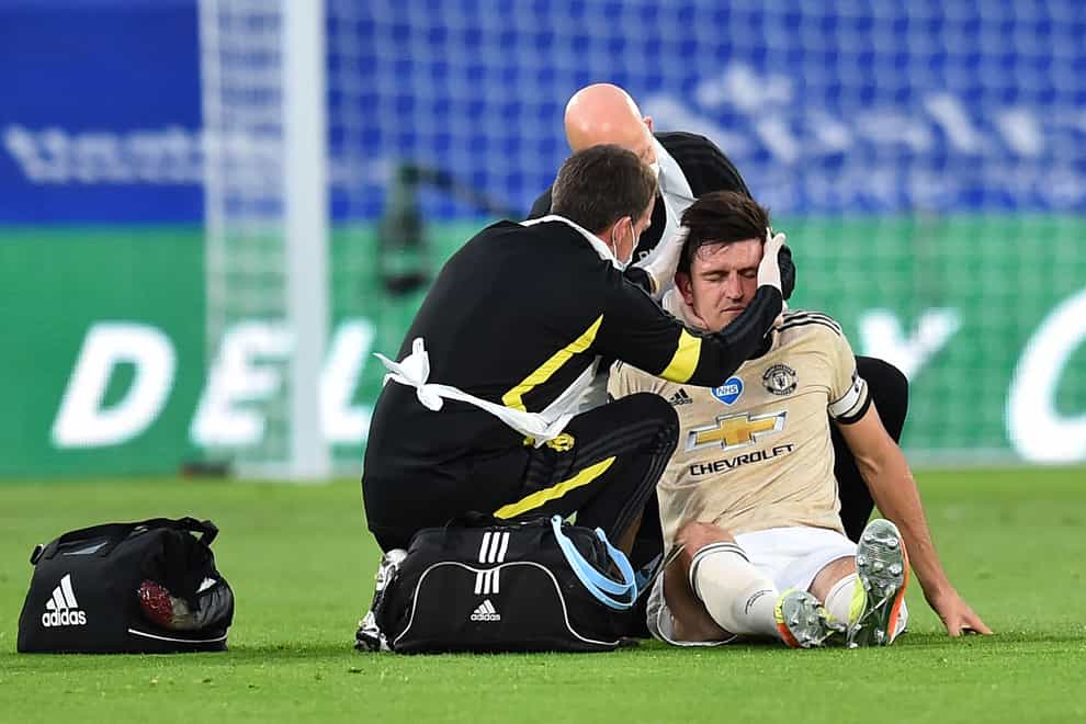 Manchester United’s Harry Maguire receives treatment for a head and neck injury during a match against Crystal Palace