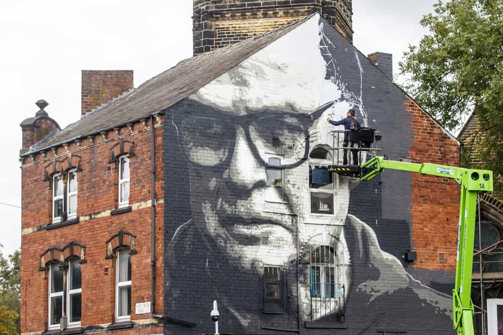 Artist Irek Jasutowicz works on a new mural of Leeds manager Marcelo Bielsa near Hyde Park in Leeds