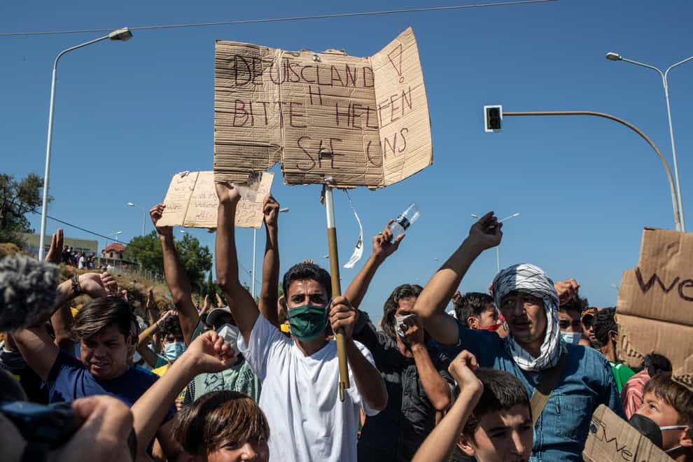 Migrants take part in a rally on Lesbos