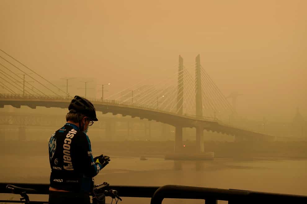 Smoke from wildfires partially obscures the Tilikum Crossing Bridge in Portland